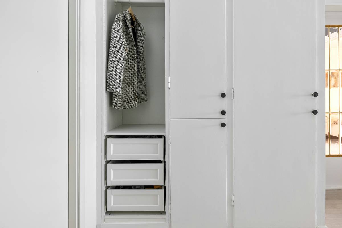 trendy smart wardrobe featuring integrated LED lighting, RFID garment tags, and minimalist matte-black frame in a modern bedroom setting